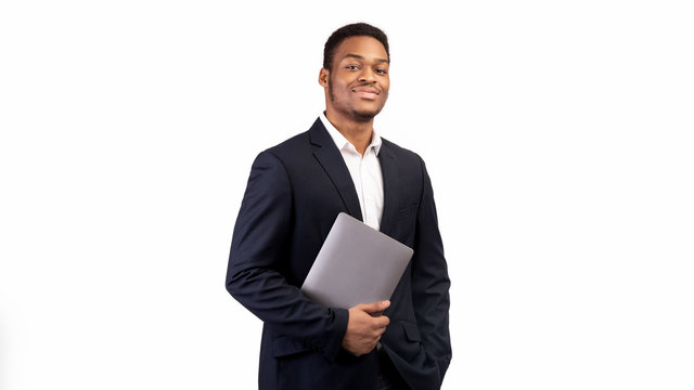 Handsome black man holding laptop on white background