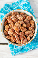 caramelized almonds on white wooden surface