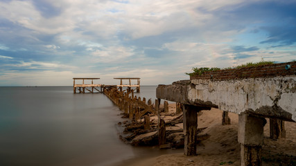 Dilapidated old fishing dock collapsing into the sea in Pak Nam Pran Thailand