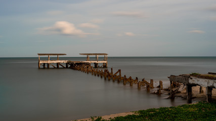 Obraz premium Dilapidated old fishing dock collapsing into the sea in Pak Nam Pran Thailand