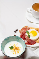 yogurt, fried eggs with meat and bread and place for text