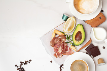 breakfast of avocado, coffee, bacon and lemon and place for text