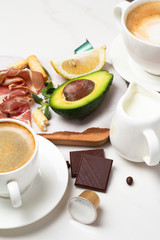 healthy breakfast with avocado, bacon, porridge, chocolate and coffee