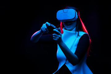 Fototapeta na wymiar Woman with virtual reality headset is playing game.