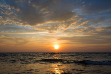 Sunrise over the ocean and beautiful cloudscape. View from the beach