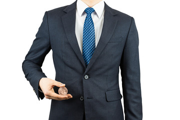 A person wearing a suit and holding a bitcoin in his hand.