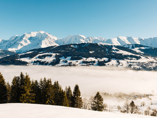 the valley at Sallanches covered with fog on a sunny bright day in the French Mont Blanc massive