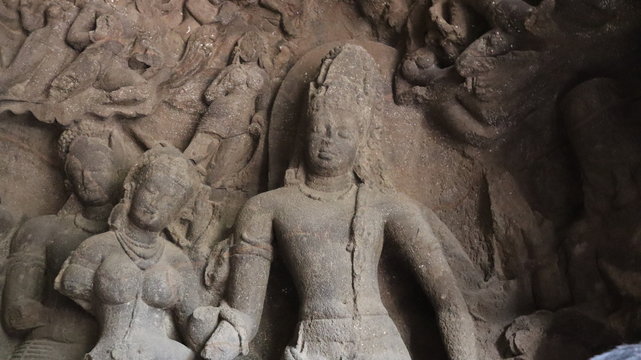 Mumbai, Maharastra/India- January 13 2020: Old statue carved on the mountain rock. Buddhist art in ancient hindu temple.