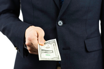 A man in a suit with a dollar in his hand.