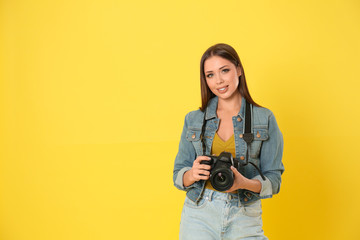 Professional photographer working on yellow background in studio. Space for text - obrazy, fototapety, plakaty