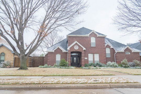 Typical two story house in winter snow cover near Dallas, Texas