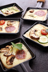 Delicious traditional Swiss melted raclette cheese on diced boiled or baked potato.