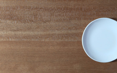 White saucer and wooden background