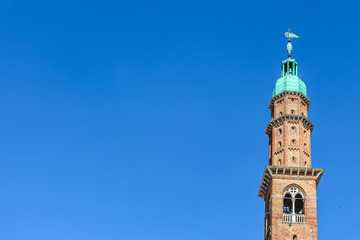 Vicenza, Italy. View of clock tower (Torre Bissara) at famous square (Piazza dei Signori) in Vicenza.