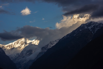 Fototapeta na wymiar A view of the clouds covering the Machapuchare aka the Fishtail mountain on the Annapurna Base Camp trail in the Nepal Himalayas.