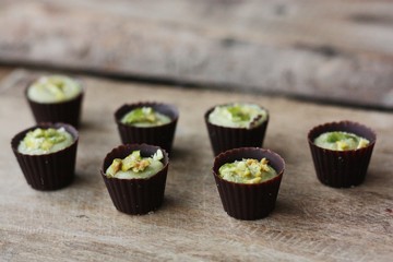 Delicious chocolate candies with pistachios on the table