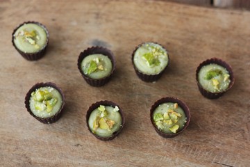 Delicious chocolate candies with pistachios on the table
