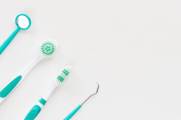 Toothbrushes and hygiene products on a white background. Top view.