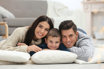 Fototapeta premium Happy family with little son spending time together at home. Winter vacation