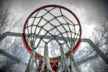 Selective focus on a basketball hoop. Cloudy day. Vibrant.