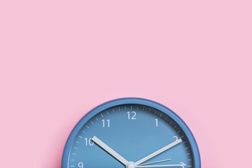 Cropped image of clock on pink background.