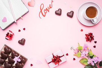Concept Valentine's Day. Chocolate candies and coffee, hearts on a pink background. Flat lay copy space. Greeting card and gift.