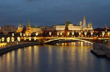 Evening view of the Moscow Kremlin and the Big Stone bridge with festive illumination. Moscow, Russia