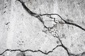 Ruined concrete wall, crack and hole in the cement slab. Grunge surface, danger concept. Damage effect, texture. Gray stone background, material.