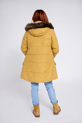 back view of woman in warm winter clothes posing over grey © Di Studio