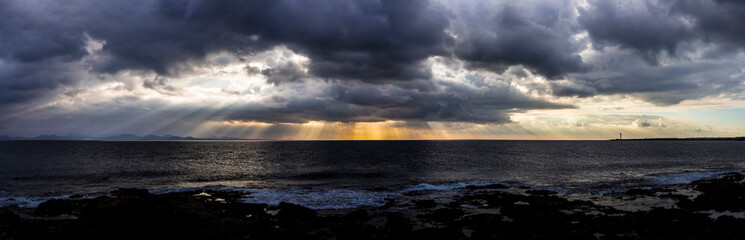 Inspirational Light, coming through the clouds. Showing us there is still hope, there always is. Awesome view of clouds over sea, with rays of sunlight bursting from the clouds.
