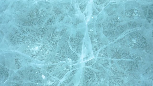 CLOSE UP: Beautiful turquoise water of Lake Abraham freezes in the winter cold. Stunning shot of beautiful patterns naturally occurring underneath the frozen surface of a lake in the Canadian Rockies.