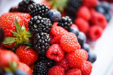 fresh berries close up - strawberries, blueberries, red berries, raspberry, black berries 