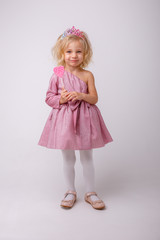 beautiful little blonde girl with a heart shaped Lollipop