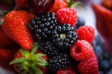 fresh berries close up - strawberries, blueberries, red berries, raspberry, black berries 