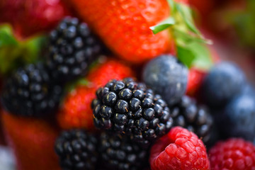 fresh berries close up - strawberries, blueberries, red berries, raspberry, black berries 