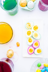 Coloring hard-boiled eggs easter tradition, naturally dyed eggs for easter holiday using natural ingredients, top view flat lay composition