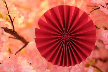 close up traditional Japanese paper art (Origami ) with blur pink sakura background. Japanese culture concept