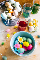 Fototapeta na wymiar Coloring hard-boiled eggs easter tradition, naturally dyed eggs for easter holiday using natural ingredients, top view flat lay composition