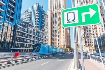 Foto op Canvas Modern city transport tram in downtown Dubai Marina with Skyscrapers © EdNurg