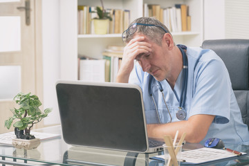 Fototapeta premium Overworked doctor in his office