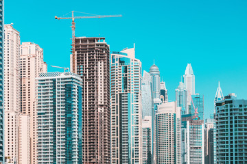 Fototapeta na wymiar Construction of skyscrapers in the new district of Dubai - Marina