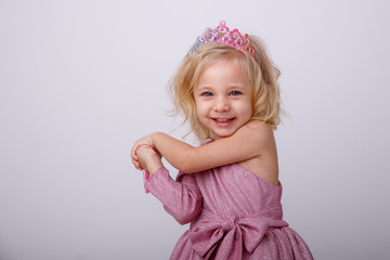 beautiful little blonde girl with a heart shaped Lollipop