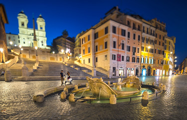 Night view of Spanish Steps and  Fontana della Barcaccia in Rome, Italy.