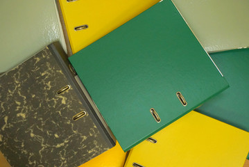 Multicolored stationery folders. Plastic folders with documents. Top view