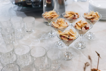 Fototapeta na wymiar Caesar salad with crackers, cheese, chicken and tomato in glasses for a snack