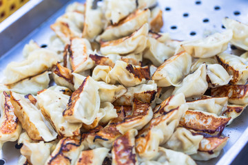 Pork and Cabbage Dumplings (Guotie or Jiaozi). Pile of gyoza. Gyoza Japanese style. Asian street food. Regional Food