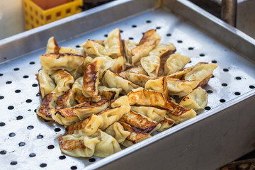 Pork and Cabbage Dumplings (Guotie or Jiaozi). Pile of gyoza. Gyoza Japanese style. Asian street food. Regional Food