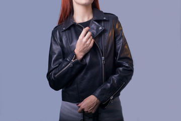 portrait of a girl in a high-quality leather jacket. Rock and roll style in women. Promotional photo of a leather jacket