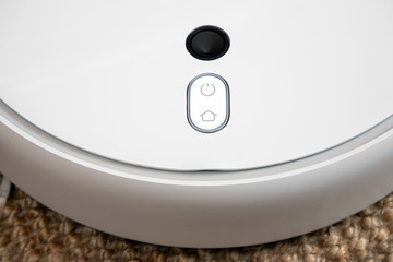 Robot vacuum cleaner performs automatic cleaning of the apartment at a certain time. Smart home.