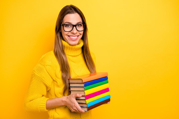 Turned photo of cool confident library worker copyspace want start success fall studying day hold pile stack books wear knitted collar jumper isolated bright yellow color background - obrazy, fototapety, plakaty